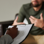 Therapist guiding a young adult during an intervention session, symbolizing hope and support