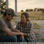 A middle-aged woman with a compassionate, concerned expression is crouched, gently placing a hand on the forearm of a young adult man, who sits with his head bowed and a thoughtful, heavy expression.